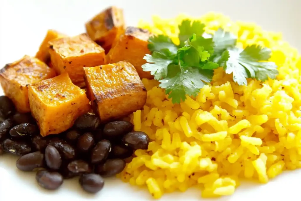 Bright plate of rice with black beans, roasted sweet potatoes, and fresh cilantro.
